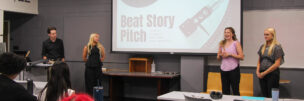 Students make a presentation in front of a screen that says "Beat Story Pitch."
