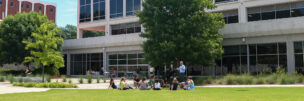 A group of public relations students enjoy class outside.