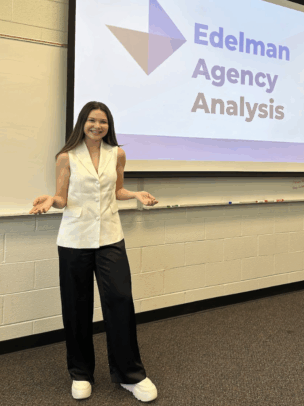 Melisa Bordianu stands in front of a screen that says "Edelman Agency Analysis."